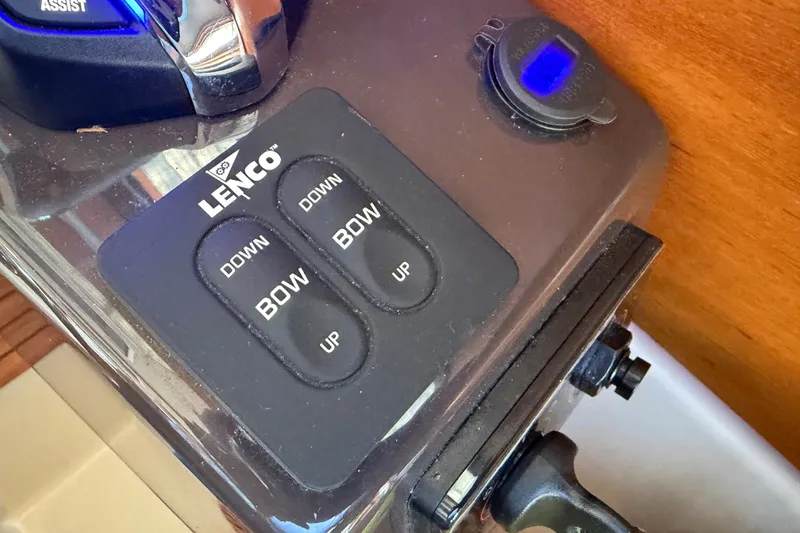 Slide: The Image of Lenco trim tab controls on 2024 Ranger Tugs R-27 boat dashboard. - 35