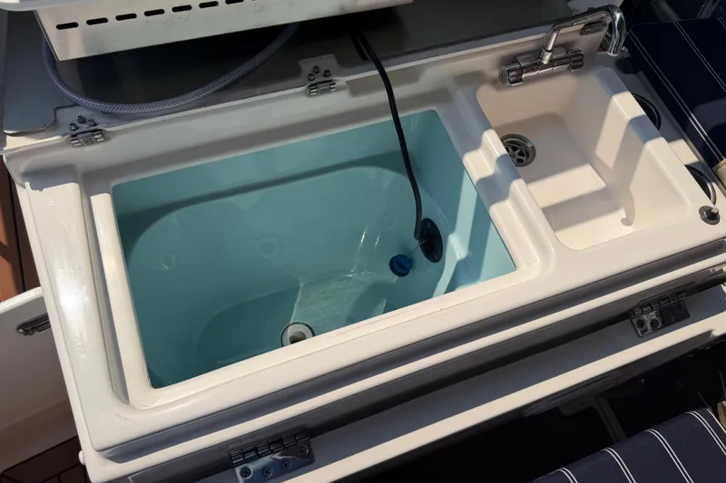 Slide: The Image of 2024 Ranger Tugs R-27 boat sink and storage compartment, featuring a modern design. - 10