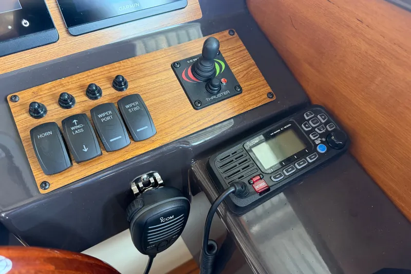 Slide: The Image of Control panel of 2024 Ranger Tugs R-27 with switches and communication device. - 32