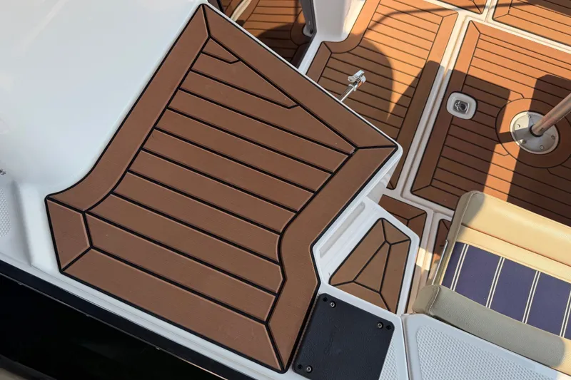 Slide: The Image of 2024 Ranger Tugs R-27 boat deck with brown and beige marine flooring. - 2