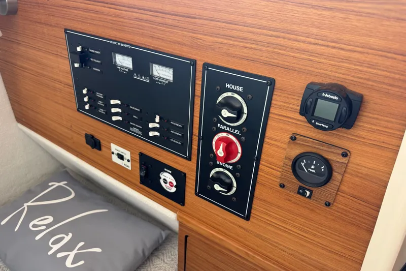 Slide: The Image of Control panel of 2024 Ranger Tugs R-27 boat with wood finish and "Relax" pillow. - 50