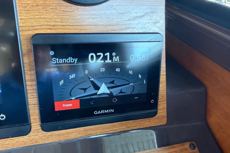 Slide: The Image of Garmin navigation display on 2024 Ranger Tugs R-27 boat dashboard, showing compass and speed. - 30