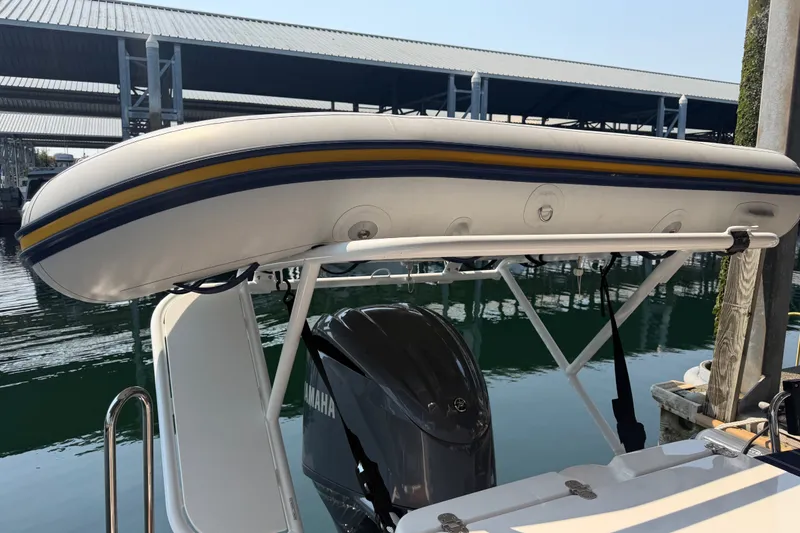 Slide: The Image of 2024 Ranger Tugs R-27 with Yamaha engine and inflatable boat on top. - 15