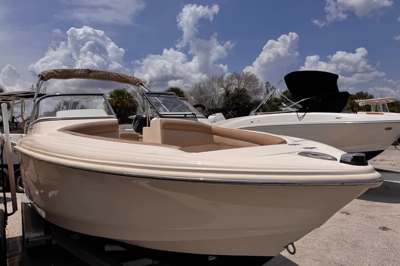 Slide: The Image of 2023 Scout 210 Dorado boat displayed outdoors under a partly cloudy sky. - 4