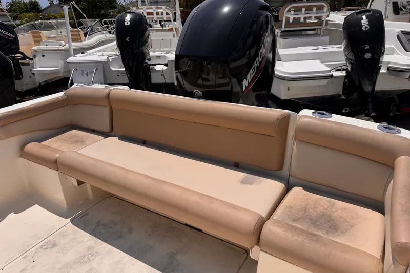 Slide: The Image of 2023 Scout 210 Dorado boat with tan seating and Mercury outboard engines. - 6
