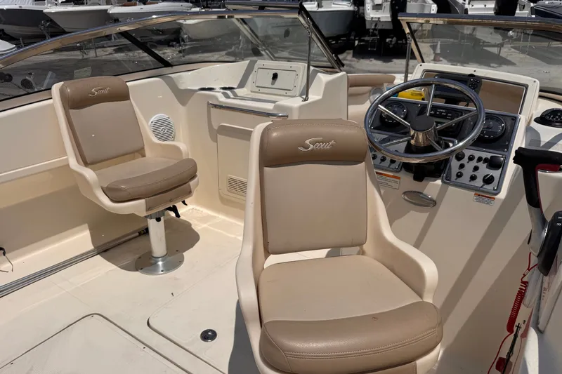 Slide: The Image of 2023 Scout 210 Dorado boat interior with steering wheel and seating. - 10