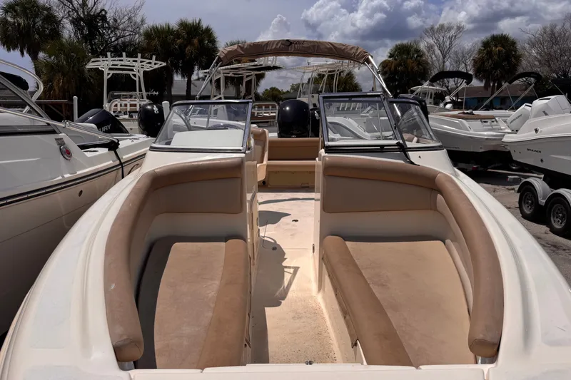 Slide: The Image of 2023 Scout 210 Dorado boat with spacious seating, parked among other boats. - 8