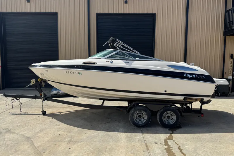 The Image of 2007 Kayot Z 220 boat on trailer, parked outside a building. - 0