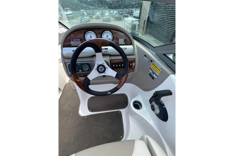 Slide: The Image of 2007 Kayot Z 220 boat dashboard with steering wheel and control panel. - 9