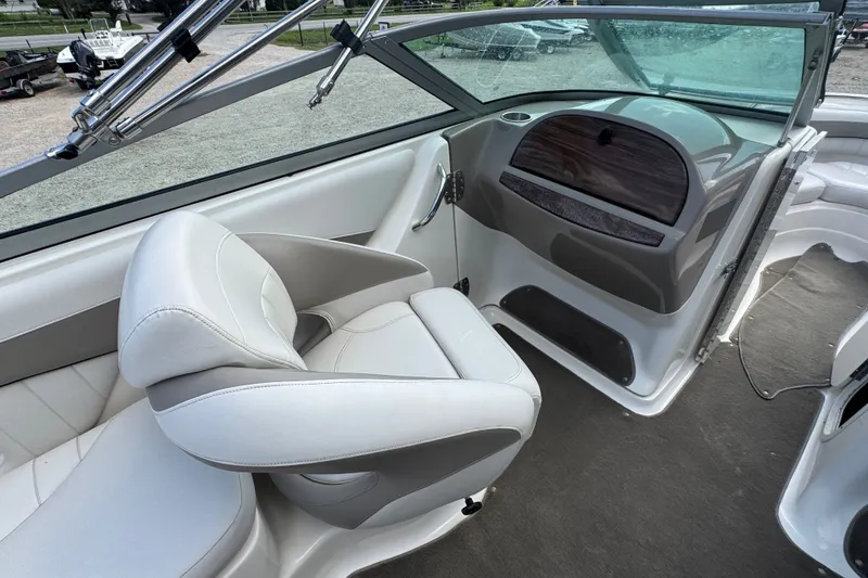 Slide: The Image of Interior of a 2007 Kayot Z 220 boat featuring white seating and dashboard. - 7