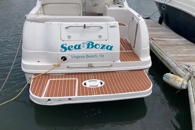 Slide: The Image of 2002 Sea Ray Sundancer 260 docked in Virginia Beach, featuring teak-style swim platform. - 15