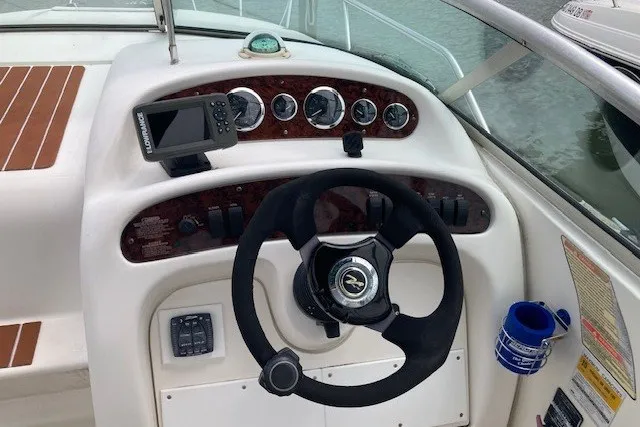 Slide: The Image of Cockpit of 2002 Sea Ray Sundancer 260 with steering wheel and navigation instruments. - 14