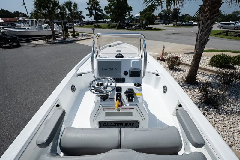 Slide: The Image of 2027 Blazer PureBay 2400 boat interior with Garmin navigation, steering wheel, and seating. - 8