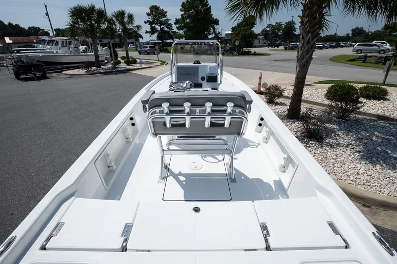 Slide: The Image of 2027 Blazer PureBay 2400 boat, sleek design, spacious deck, parked outdoors under palm trees. - 7