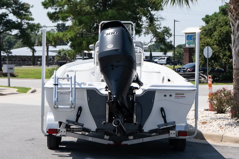 Slide: The Image of 2027 Blazer PureBay 2400 boat on trailer with powerful outboard motor. - 5