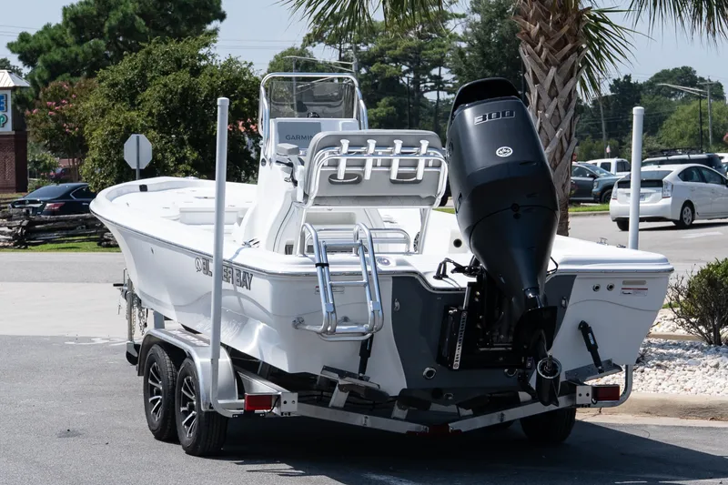 Slide: The Image of 2027 Blazer PureBay 2400 boat on trailer, parked outdoors, rear view. - 4