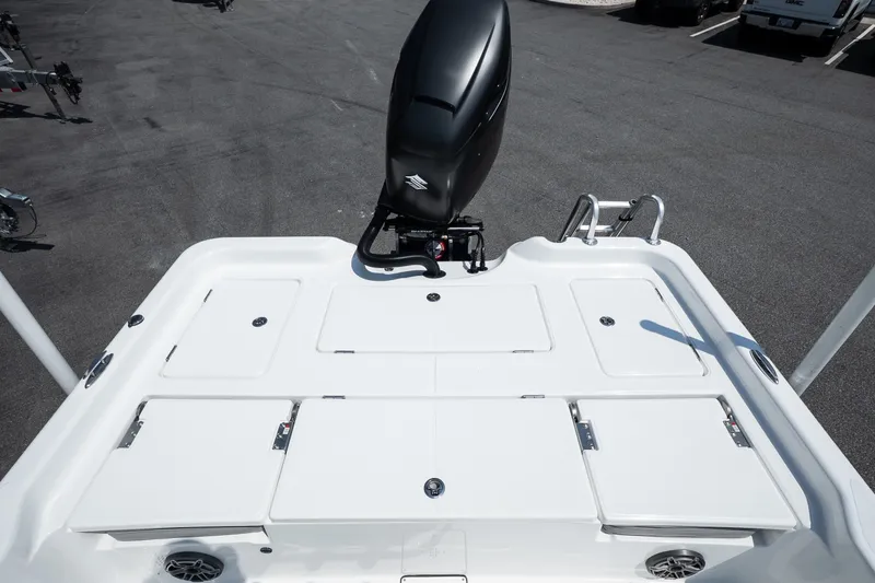 Slide: The Image of 2027 Blazer PureBay 2400 boat deck with outboard motor, showcasing storage compartments. - 13