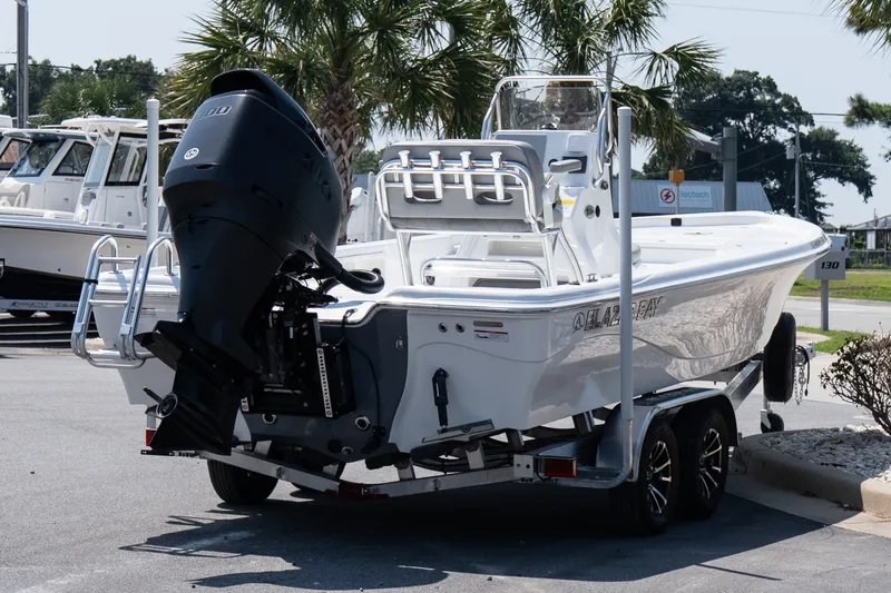 Slide: The Image of 2027 Blazer PureBay 2400 boat on trailer, parked outdoors near palm trees. - 6