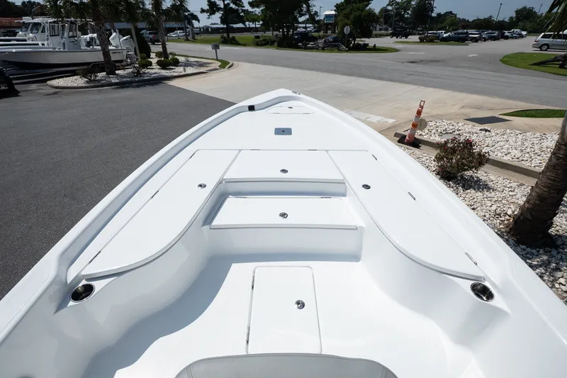 Slide: The Image of 2027 Blazer PureBay 2400 boat deck, sleek design, parked outdoors. - 9