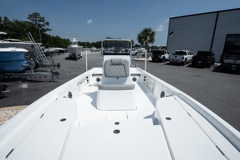 Slide: The Image of 2027 Blazer PureBay 2400 boat displayed in a marina parking lot. - 10