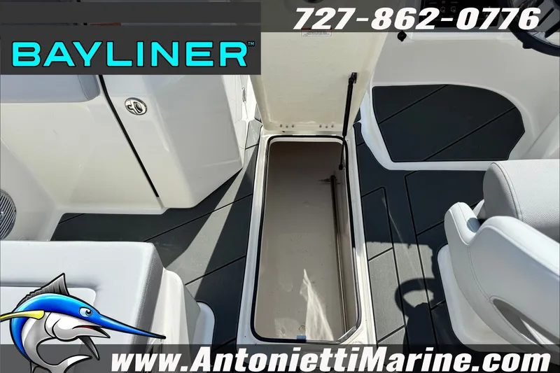 Slide: The Image of 2026 Bayliner D22 boat interior with open storage compartment, featuring sleek seating and flooring. - 24