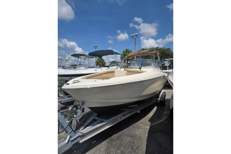 Slide: The Image of 2022 Scout 210 Dorado boat on trailer under blue sky. - 6