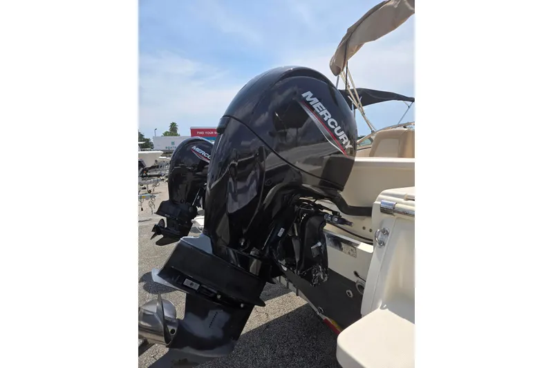 Slide: The Image of 2022 Scout 210 Dorado boat with Mercury outboard motor, parked outdoors. - 5