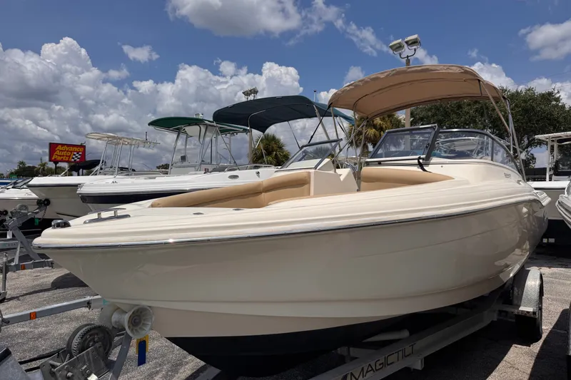 The Image of 2022 Scout 210 Dorado boat on trailer under cloudy sky. - 1