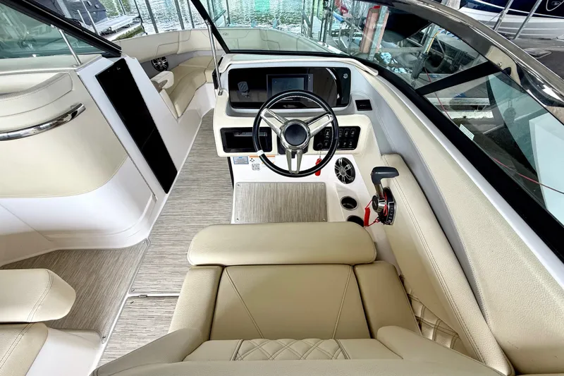 Slide: The Image of Luxurious interior of a 2019 Regal LS6 boat with beige seating and modern dashboard. - 20