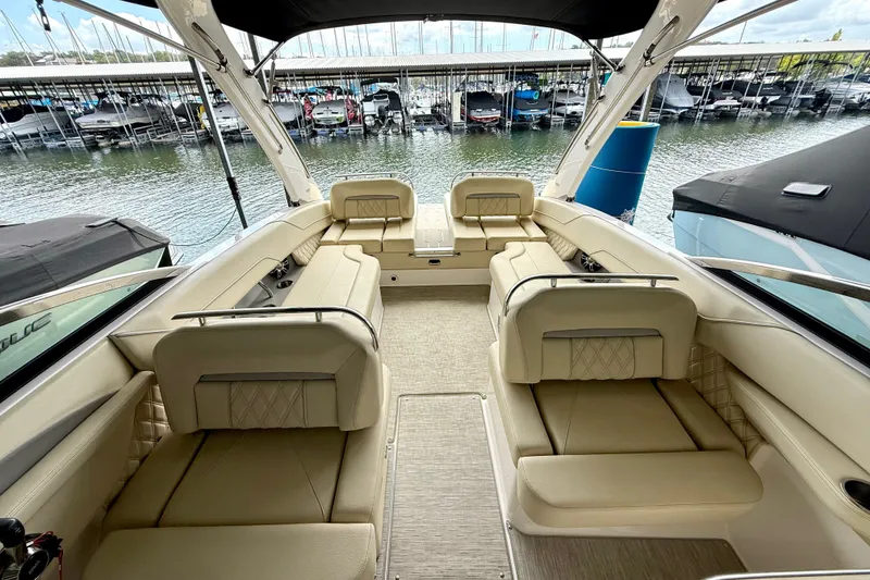 Slide: The Image of Luxurious 2019 Regal LS6 boat interior with beige seating, docked at a marina. - 17