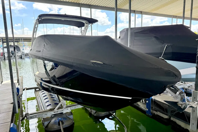 Slide: The Image of 2019 Regal LS6 boat covered and docked in a marina. - 40