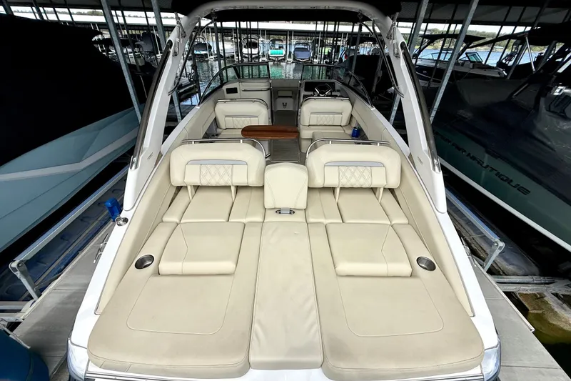 Slide: The Image of 2019 Regal LS6 boat with beige seating, docked in a marina. - 24