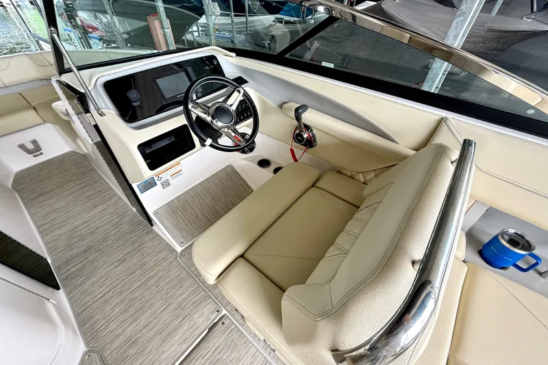 Slide: The Image of 2019 Regal LS6 boat interior with steering wheel and beige seating. - 19