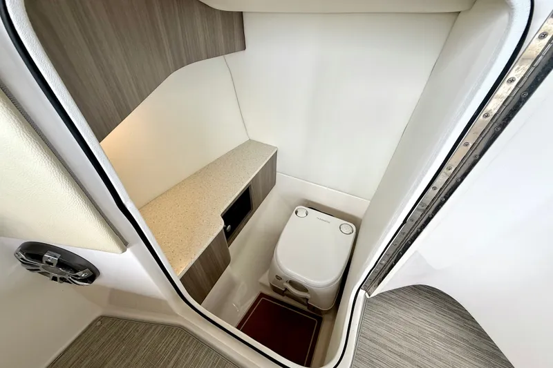 Slide: The Image of Compact bathroom in 2019 Regal LS6 boat with modern design and efficient layout. - 28