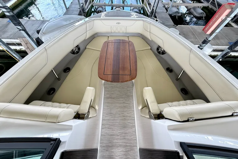 Slide: The Image of Luxurious 2019 Regal LS6 boat interior with elegant seating and wooden table. - 26