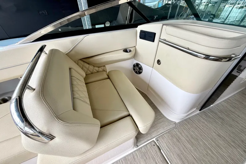Slide: The Image of Luxurious interior seating of a 2019 Regal LS6 boat, featuring beige upholstery and chrome accents. - 22