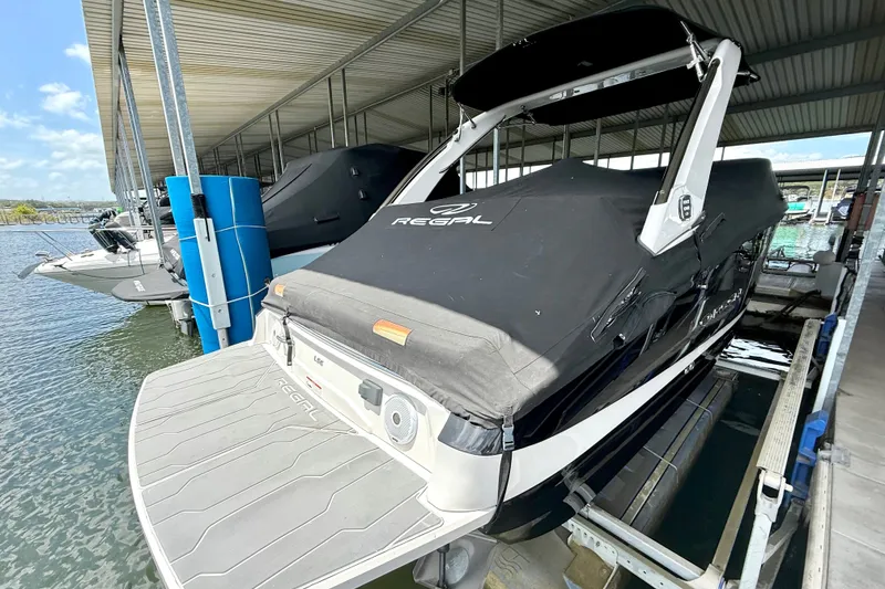 Slide: The Image of 2019 Regal LS6 boat docked under a covered marina. - 39