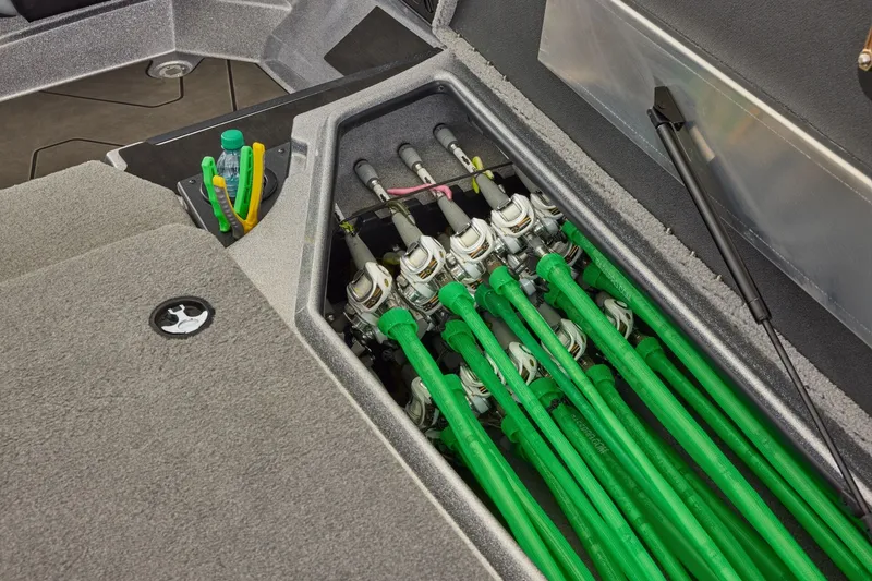 Slide: The Image of Manufacturer Provided Image: Manufacturer Provided Image: Fishing rod storage compartment in a 2027 Nitro Z18 XL boat, featuring organized green rods. - 15