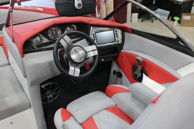 Slide: The Image of 2017 Tigé Z3 boat interior with red and gray upholstery, modern dashboard, and steering wheel. - 13
