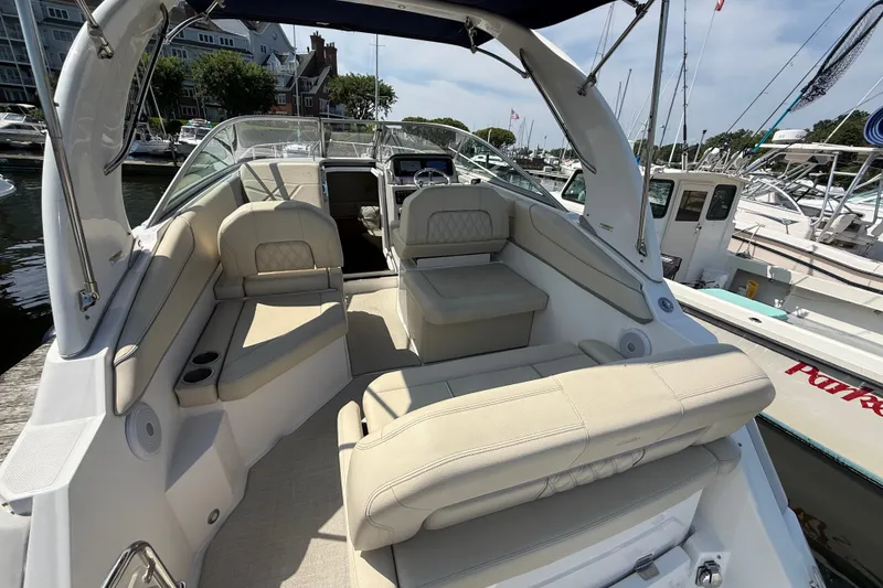 Slide: The Image of 2023 Regal 26 XO boat interior with luxurious seating and modern design at a marina. - 7