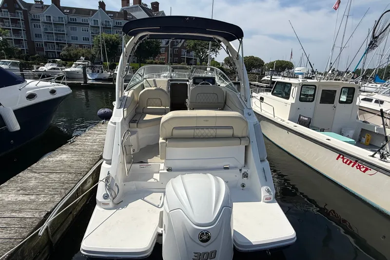 Slide: The Image of 2023 Regal 26 XO boat docked at marina, showcasing sleek design and spacious seating. - 3