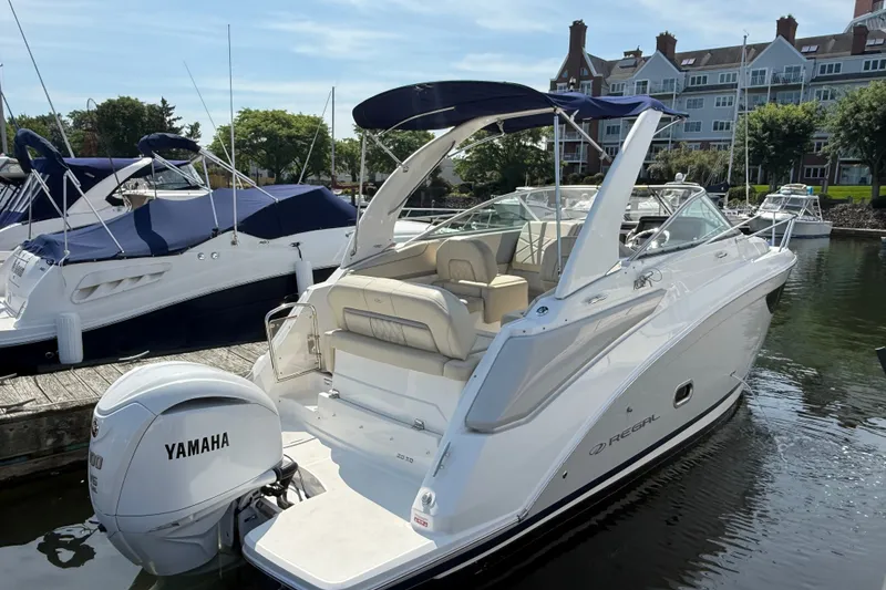 The Image of 2023 Regal 26 XO boat docked, featuring Yamaha outboard motor, luxury seating, and sleek design. - 0
