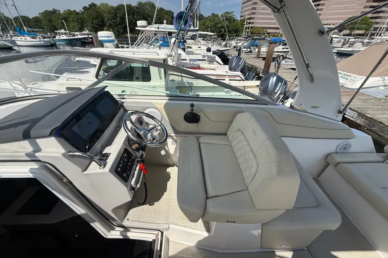 Slide: The Image of 2023 Regal 26 XO boat interior with modern helm and seating at marina. - 15
