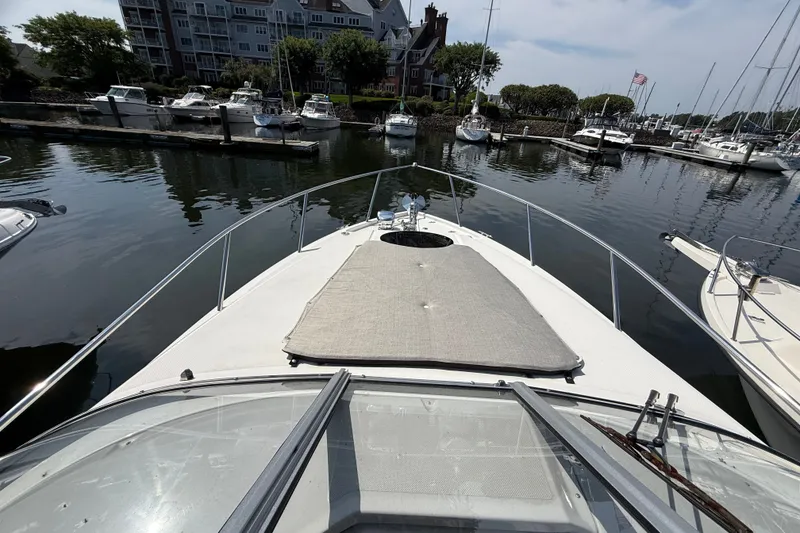 Slide: The Image of 2023 Regal 26 XO boat docked in a marina, surrounded by other vessels. - 21