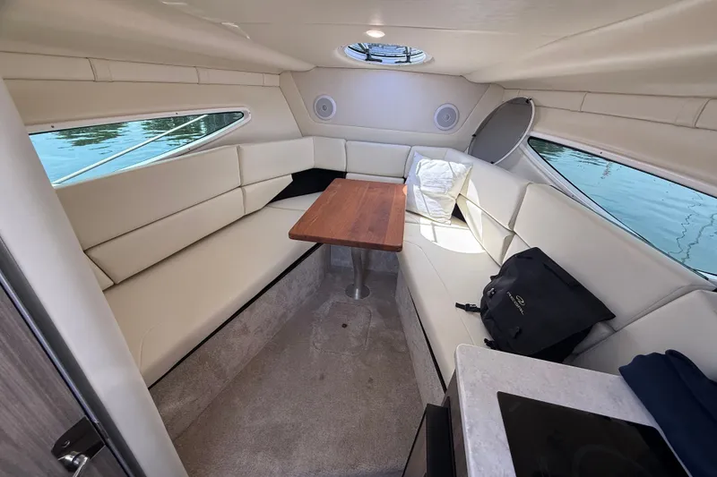 Slide: The Image of Luxurious interior of 2023 Regal 26 XO boat with plush seating and wooden table. - 26