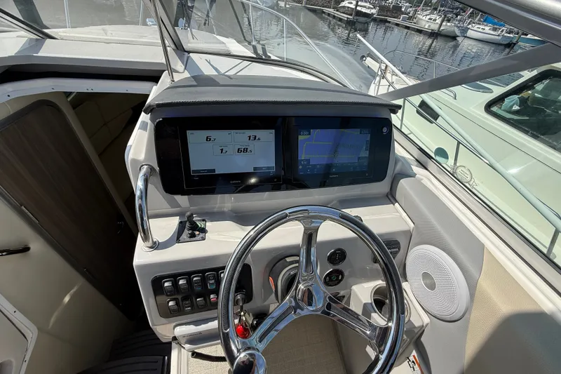 Slide: The Image of 2023 Regal 26 XO boat helm with modern dashboard and steering wheel. - 17