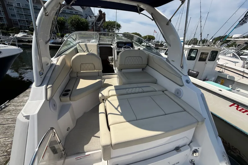 Slide: The Image of 2023 Regal 26 XO boat interior with luxurious seating at a marina dock. - 8