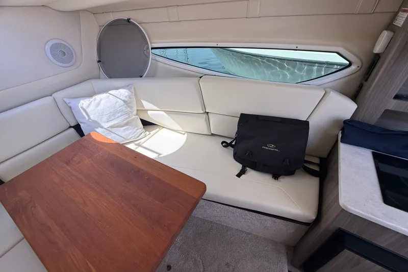 Slide: The Image of Interior of 2023 Regal 26 XO boat with seating, table, and bag. - 27