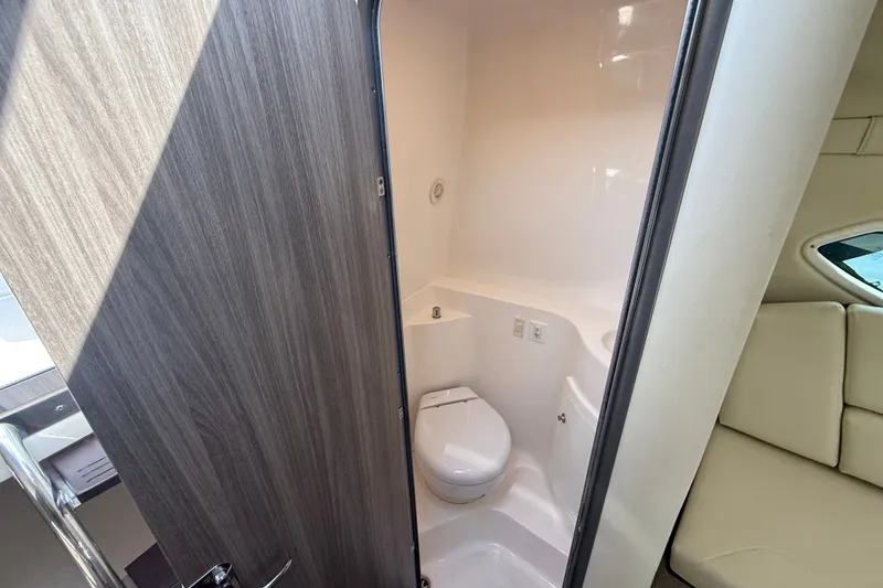 Slide: The Image of 2023 Regal 26 XO boat interior bathroom with modern design and wooden door. - 36