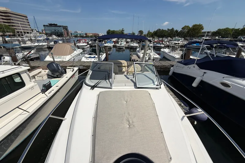 Slide: The Image of 2023 Regal 26 XO boat docked in a marina, surrounded by other vessels. - 23